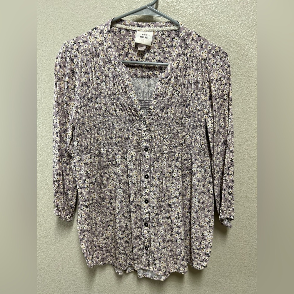 Pretty purple w/little white daisies. Buttons down front and smocking.